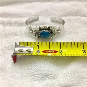 Silvertone bracelet with turquoise colored stones.